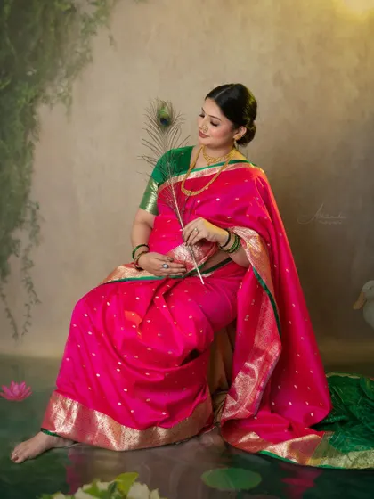 Another beautiful pose with a peacock feather, symbolizing grace and beauty. The mom-to-be's expression is full of serene joy.