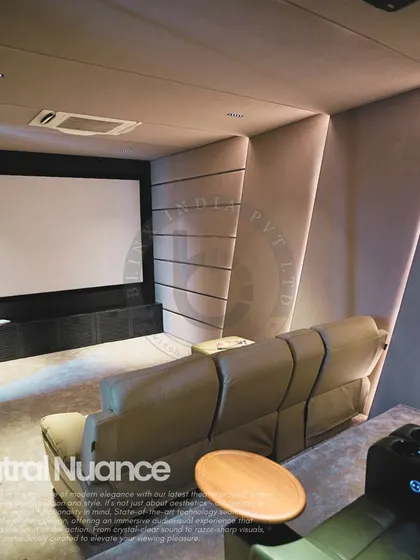 This project showcases a modern, minimalist aesthetic with its neutral beige color palette and clean lines. We integrated angled acoustic wall panels with recessed LED lighting to create a visually dynamic space that also delivers exceptional sound quality for an immersive home theater experience.