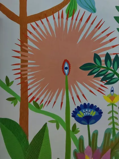 A close-up of one of the unique, spiky flowers from the staircase mural, featuring an eye motif for a touch of playful charm.