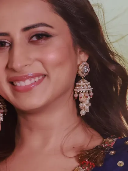 A detailed shot of the pearl and polki jhumkas worn by Sargun Mehta, highlighting the delicate craftsmanship.