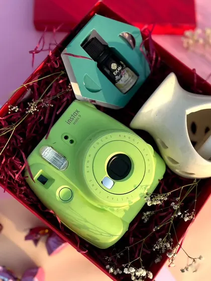 Another angle of our popular Valentine's hamper, showing the arrangement of the Instax camera, oil, and ceramic diffuser.