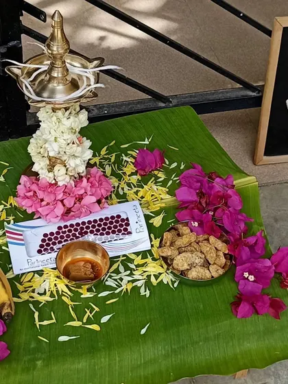 A close-up of the Onam offerings, including bananas, flowers, and traditional sweets.