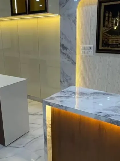 A view of the custom counters and reception desk. The mix of a marble-top desk and a simple, functional counter provides different zones for client interaction and work.