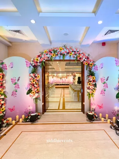 We designed this vibrant and welcoming entrance for a Haldi ceremony, using a spectrum of colorful flowers and whimsical butterfly details to create a captivating and joyful atmosphere for guests.
