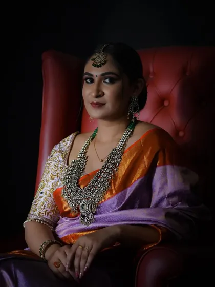 A portrait shot that captures the regal feel of our lavender silk saree. The rich color and traditional border make it a sophisticated option for any formal occasion.