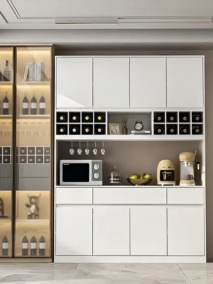 A modern bar and crockery unit in white, with dedicated wine racks, glass holders, and a countertop for serving.