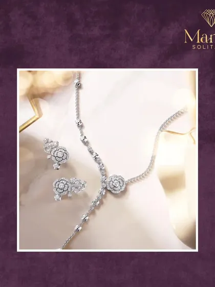 A delicate and modern set. This beautiful white gold collection includes a floral-inspired necklace, matching earrings, and a simple bracelet, all adorned with sparkling diamonds.