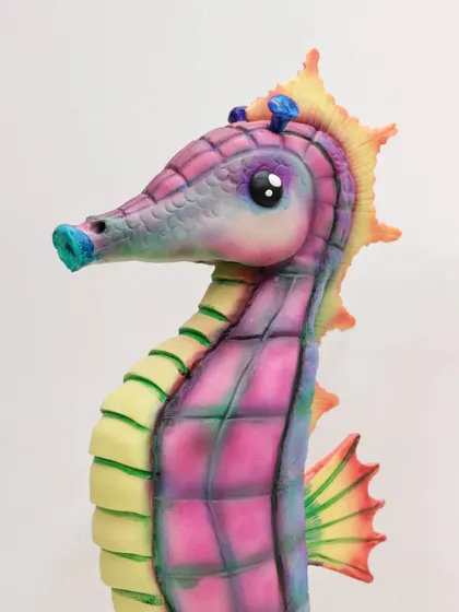 A close-up of the sculpted seahorse cake, showing the airbrushed color blending and detailed texture work. We cover these finishing techniques to bring your sculpted cakes to life.
