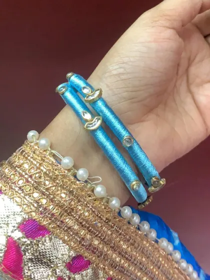 A very simple and elegant pair of light blue silk thread bangles with minimal kundan work. Perfect for everyday wear.
