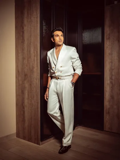 A full-length view of Pratik Gandhi in our tailored white ensemble. This look effortlessly blends sophistication with bold styling, exuding modern charm and timeless class.