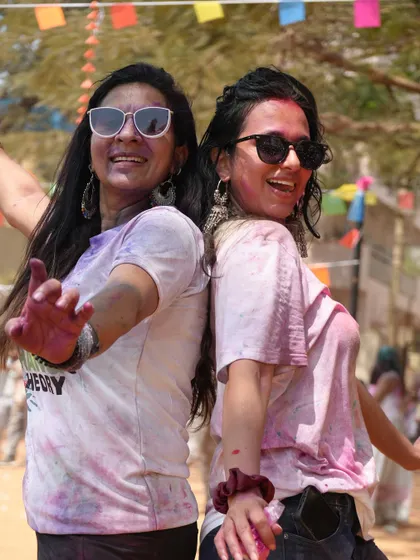 Dancing back-to-back with a friend at a Holi event. My parties are all about connecting with others and sharing the joy of the festival.