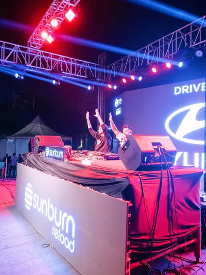 On stage at Sunburn Reload for a massive corporate event with Hyundai. I’m not just a DJ, I'm on the mic, hyping up thousands and making sure everyone is part of the show.