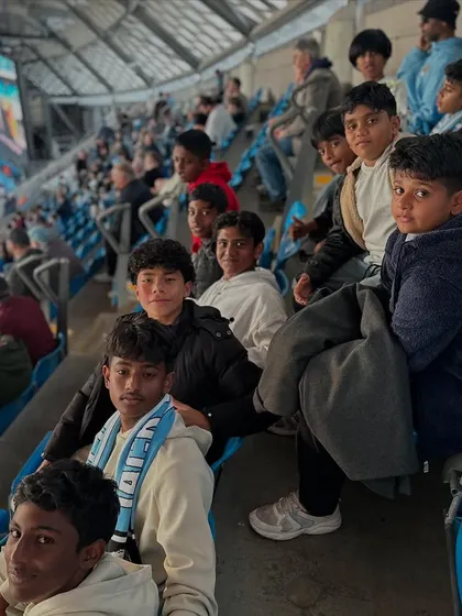 Our players watching a live match from the stands, an inspiring experience for any young footballer.