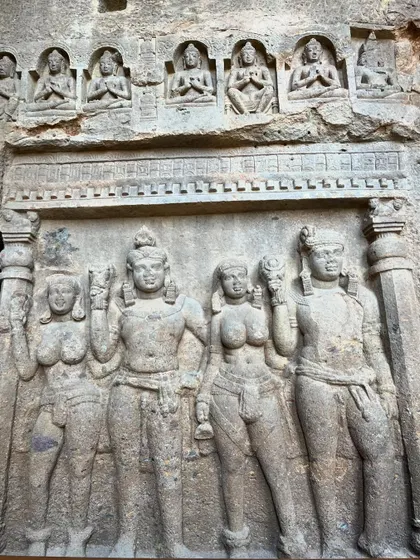 An intricate panel of carved figures at Kanheri Caves, representing various deities and Bodhisattvas from Buddhist lore.