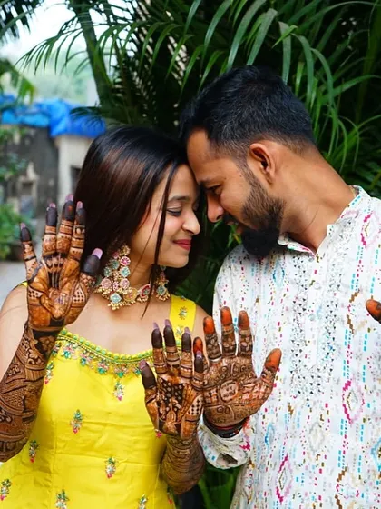A sweet moment between the bride and groom, both showing off their henna. I love doing mehendi for grooms too.
