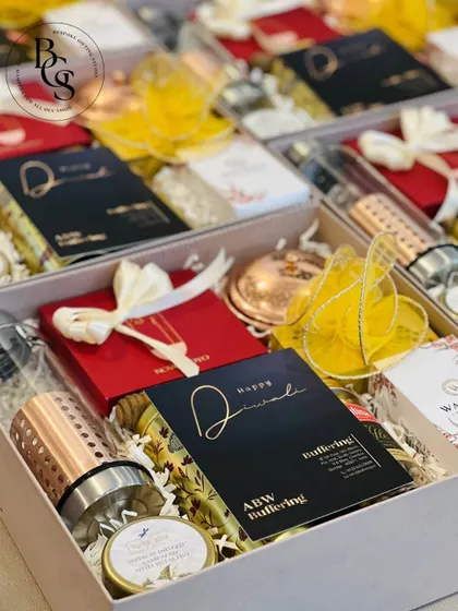 This luxury Diwali hamper includes a variety of premium items like a copper-infused water bottle and scented candles, all beautifully arranged in a custom box. It's a perfect high-end corporate gift.
