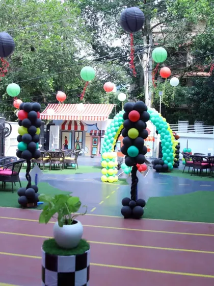 Another view of the outdoor space transformed for a Cars party. The hanging lanterns and themed balloon columns guide guests through the fun-filled racetrack.