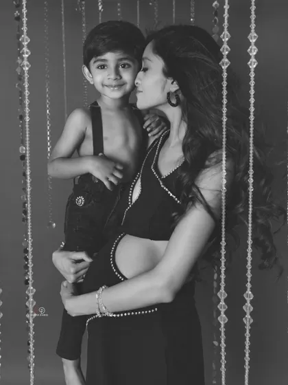 A beautiful black and white portrait of a mother and her son sharing a sweet moment. This timeless style highlights the pure love and emotion of the scene.