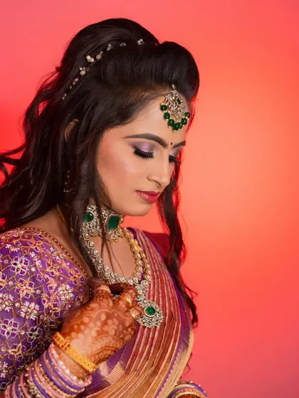 A final look at the detailed makeup and jewellery. The combination of a bold eye, radiant skin, and statement accessories creates a truly memorable reception style.