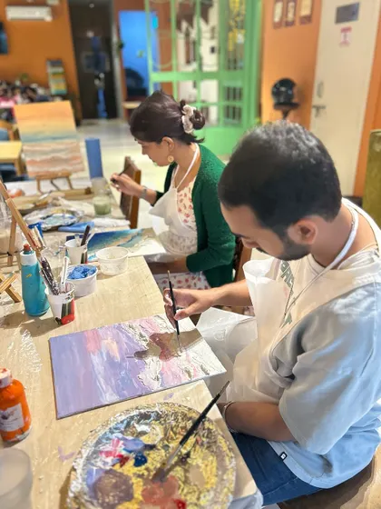 A couple painting together at a seascape workshop. It's a great way to spend quality time and be creative.