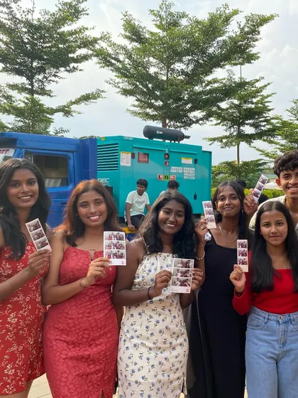 A group of friends posing with their prints at the Presidency Invincia fest.