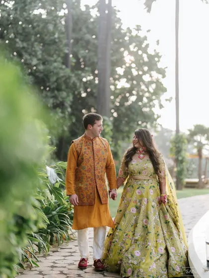 A walk in the park. This couple looks so in love, and the bride's colorful Mehndi outfit is perfect for the sunny, outdoor setting.