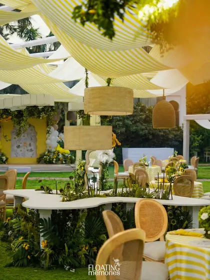 The main guest area, showing the interplay of the striped canopy, hanging decor, and beautifully set tables.