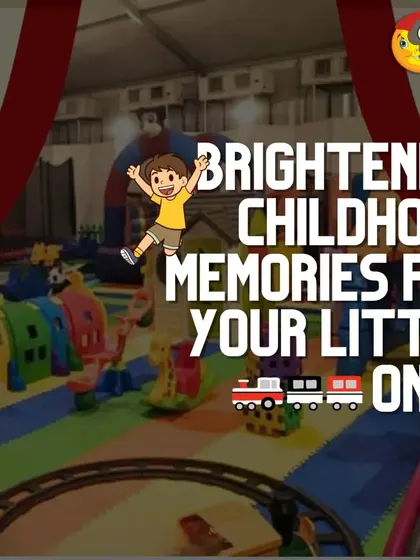 Brightening childhood memories for your little ones. This image showcases a large indoor playzone with a train track running through the center, surrounded by various climbers, rockers, and a playhouse.