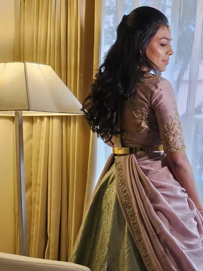 The back of Dr. Tushara's blouse features delicate embroidery, adding a touch of elegance.