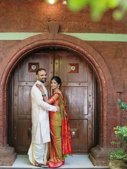 A loving embrace against a backdrop of rustic stone and an arched wooden door, creating a timeless and romantic pre-wedding portrait.