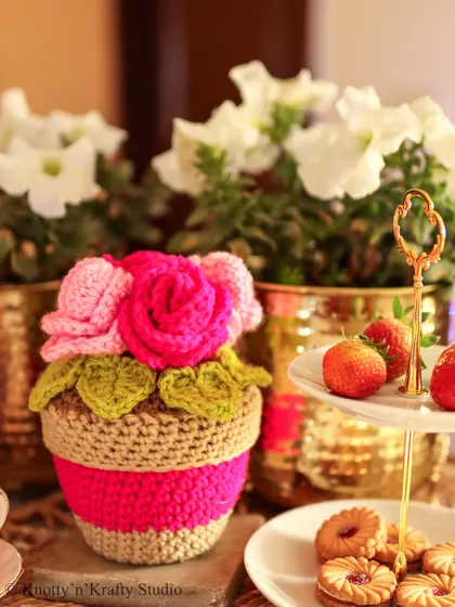 A close-up of the Rosie Posie, showing the different shades of pink and the texture of the jute pot.
