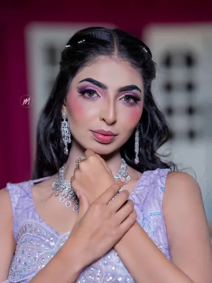 A detailed portrait focusing on the bold eye makeup and diamond jewellery.