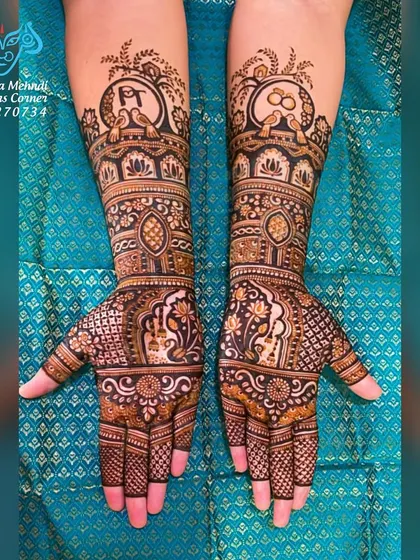 A beautiful engagement mehndi with personalized initials. The design incorporates the couple's initials and an engagement ring motif, surrounded by traditional peacock and floral patterns.