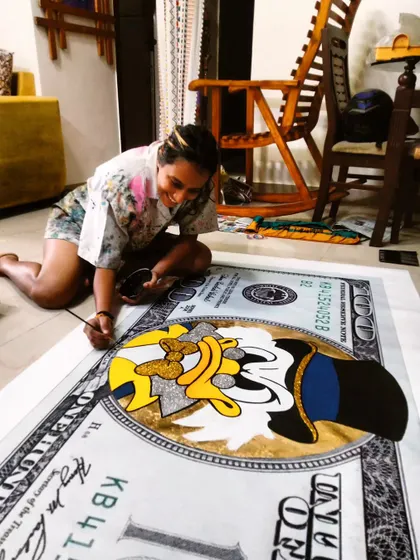 Me on the floor, painting the giant dollar bill canvas. I love working on large-scale pieces, even on canvas.