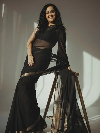 A full-body shot showing the elegant pose and the simple styling for this modern photoshoot.