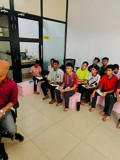 The coach uses a whiteboard to explain key concepts during a mindset training session. We invest in our students' mental game, teaching focus, resilience, and strategy.