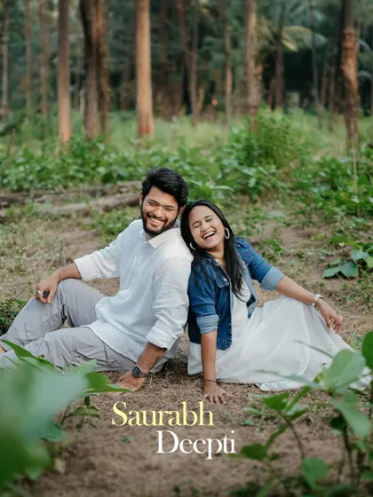 A lovely portrait of a couple sitting back-to-back in a wooded area, laughing. The text overlay with their names makes this a perfect choice for a casual save the date.