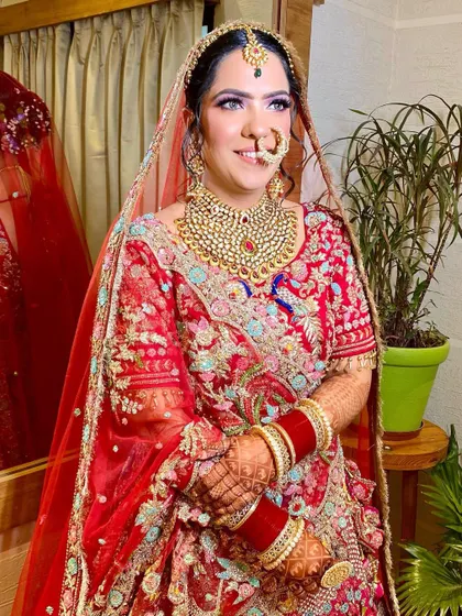 A close-up of this beautiful bride's smiling face. The makeup is soft and pretty, with a focus on rosy cheeks and a natural lip.