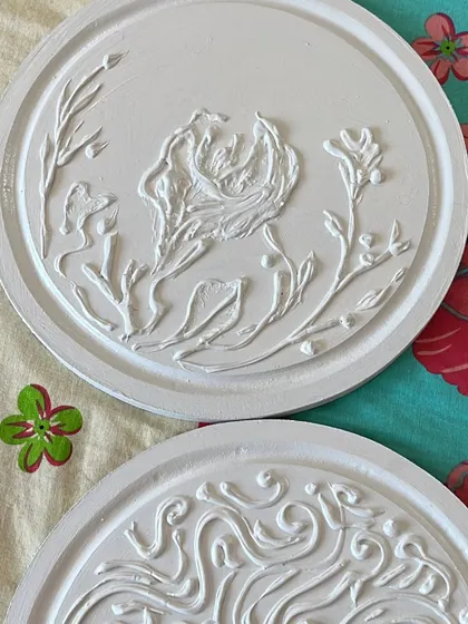 A close-up of the two white textured art pieces from the set. I use sculpture and texture techniques to add depth and interest to the collection.