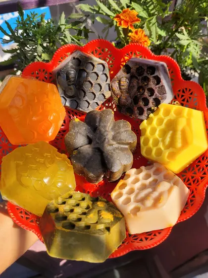 A beautiful assortment of my handmade soaps in a basket. You can see different types, from charcoal and ubtan to honey-based bars.