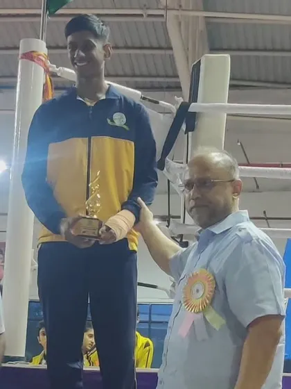 Mohit Kumaran R. on the podium after winning a silver medal at the CISCE National Boxing Championship. Competing at the national level requires immense focus, and I prepare my students for that pressure.