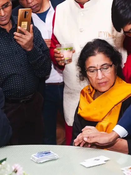 A close-up card trick where the guest is completely focused. This intimate setting allows for some of the most powerful and memorable illusions.