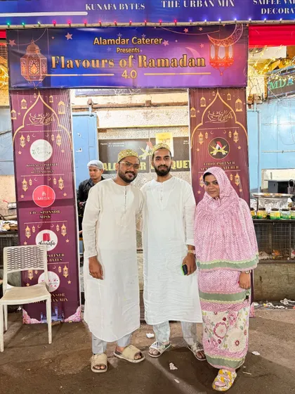 A family enjoying the festive decorations and vibrant setting of our annual food event in Mazgaon.