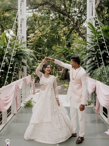 A playful moment as the groom twirls his bride on a bridge at their engagement shoot.