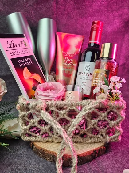 A perfect hamper for a romantic date night. This basket includes Victoria's Secret products, Lindt chocolate, a scented candle, and non-alcoholic fruit champagne.