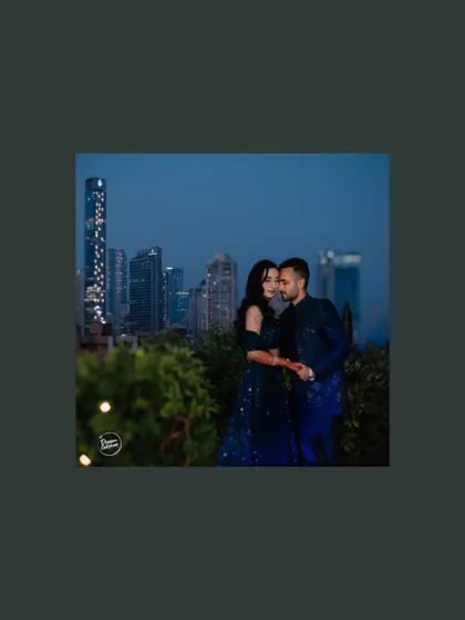A romantic moment with the Mumbai city lights twinkling in the background. This shot perfectly blends the intimacy of the couple with the grand, energetic backdrop of the city at night.