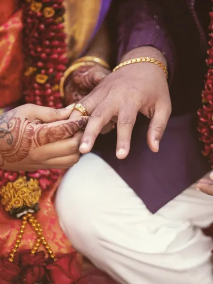 The ring exchange is a universal symbol of commitment. We capture a close-up of this important moment during the wedding ceremony.
