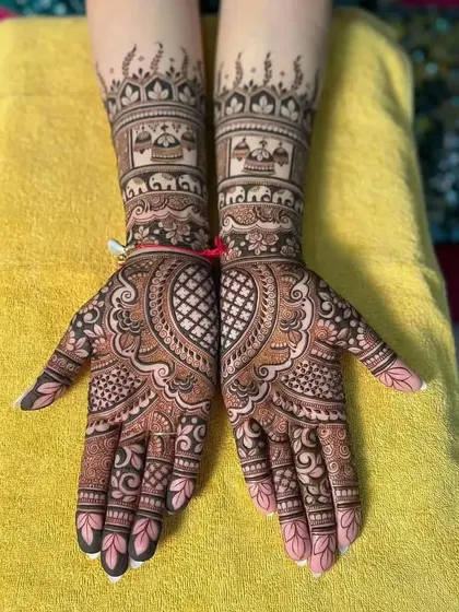 Symmetrical bridal hands featuring palace architecture at the wrists and intricate paisley patterns on the palms. The design is balanced and perfect for a royal-themed wedding.