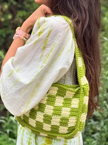 This crochet shoulder bag adds a touch of handmade style to any outfit. It's both functional and fashionable.