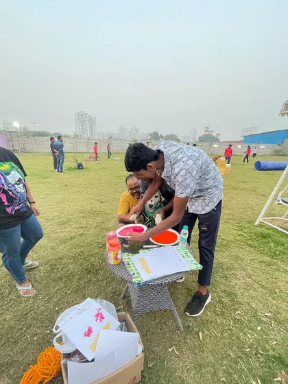 A staff member helping a guest and their furry friend make the perfect paw print. We're always on hand to help with activities.